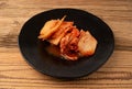 Kimchi Isolated, Kimchee on Black Plate, Red Spicy Kim Chi, Hot Fermented Napa Cabbage