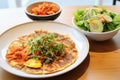 kimchi pancake accompanied by fresh salad