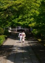 girls in Kimono dress approaching a shrine, Kyoto Japan. Royalty Free Stock Photo