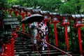 2 Kimono ladies struggled through rain to measure of faith.