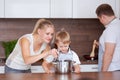 Kind caucasian parents teaching their little adorable son how to cook healthy Royalty Free Stock Photo