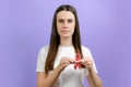 Kind cute young woman holding pink ribbon, symbol of breast cancer awareness, recommendation and warning of cancer prevention, Royalty Free Stock Photo