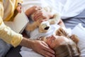 Kind grandfather read a book to little girl lying on bed Royalty Free Stock Photo