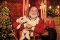 Kind grandpa with soft toys. Christmas decoration. Charity and kindness. Lovely hug. Santa Claus. Mature man with white Royalty Free Stock Photo