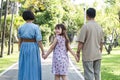 Kind-hearted Asian senior grandparent Warm and happy enjoying a stroll through the park with their adorable little Royalty Free Stock Photo