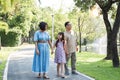 Kind-hearted Asian senior grandparent Warm and happy enjoying a stroll through the park with their adorable little Royalty Free Stock Photo