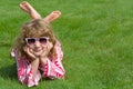 Child lies relaxed on a green meadow