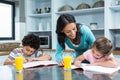 Kind mother helping her children doing homework Royalty Free Stock Photo