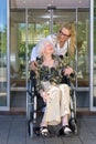 Kind Nurse Talking to Elderly Woman on Wheelchair Royalty Free Stock Photo