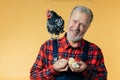 Kind positive farmer with a hen on his shoulder is holding its children