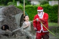 Kind Santa Claus help wash away the mud that gets on the face and eyes of the children Royalty Free Stock Photo