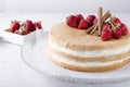 Kind of sponge cake with tasty cream and srawberry on the glass plate