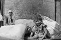 Poshina: Indian girl sitting on a chariot between goods