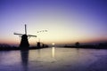 Kinderdijk - Geese flying over sunrise on the frozen windmills alignment Royalty Free Stock Photo