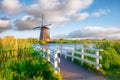 Kinderdijk National Park in the Netherlands. Windmills at the day time. A natural landscape in a historic location. Reflections on