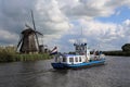 Tour boat and windmills in Kinderdijk, Holland Royalty Free Stock Photo