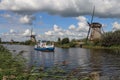 Tour boat and windmills in Kinderdijk, Holland Royalty Free Stock Photo