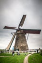 View of historic Dutch Windmill with people visiting visible