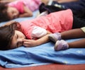 Kindergarten, children and group sleeping, relax and resting after education. Nursery, sleep and tired students take nap