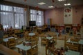 Kindergarten empty indoor view. Chairs and tables. Furniture.