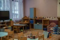 Kindergarten empty indoor view. Chairs and tables. Furniture.