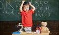 Kindergarten graduation concept. Kid boy in graduate cap ready to go to school, chalkboard on background. Child, pupil Royalty Free Stock Photo