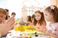 Kindergarten kids doing arts and crafts with teacher in day care centre Royalty Free Stock Photo