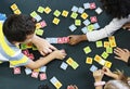 Kindergarten kids playing wooden alphabets letters vocabulary ga Royalty Free Stock Photo