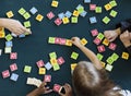 Kindergarten kids playing wooden alphabets letters vocabulary ga Royalty Free Stock Photo