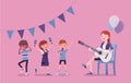 Kindergarten music party, female teacher playing guitar Royalty Free Stock Photo
