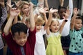 Kindergarten students with arms raised Royalty Free Stock Photo