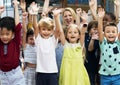 Kindergarten students with arms raised Royalty Free Stock Photo