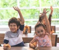 Kindergarten students hand up for pizza