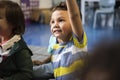 Kindergarten students sitting on the floor