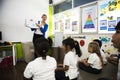 Kindergarten students sitting on the floor in the classroom Royalty Free Stock Photo