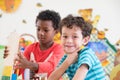 Kindergarten students smile when playing toy in playroom at pres Royalty Free Stock Photo