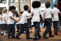 Kindergarten students standing holding hands Royalty Free Stock Photo