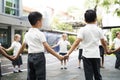 Kindergarten students standing holding hands to Royalty Free Stock Photo