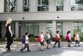 Kindergarten students walking crossing school road Royalty Free Stock Photo