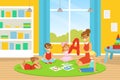 Kindergarten Teacher Explaining Alphabet to Kids, Cute Boys and Girls Learning on Floor and Learning in Kindergarten or Royalty Free Stock Photo