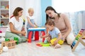 Little babies play in nursery. Developmental toys for preschool. Royalty Free Stock Photo