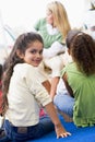 Kindergarten teacher reading to children