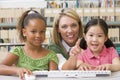 Kindergarten teacher sitting with children