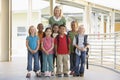 Kindergarten teacher standing with children