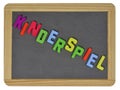 Kinderspiel in colored letters on slate