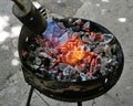 kindling coals for roasting meat on the grill using a gas Royalty Free Stock Photo