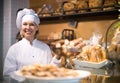 Bakery staff offering bread and different pastry for sale Royalty Free Stock Photo