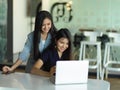 Kindly supervisor training new staff with laptop in modern office room