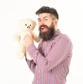 Kindness, care and tenderness concept. Guy with beard holds toy