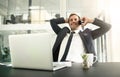 Kindness and gratitude will take you far. a businessman talking on his cellphone with his laptop in front of him. Royalty Free Stock Photo